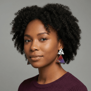 Model wearing dangle earrings with a white black polka dot triangle stud and a marbled purple-red triangle drop.