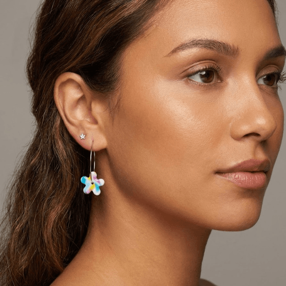 Model wearing Buttercup flower earrings handmade from polymer clay