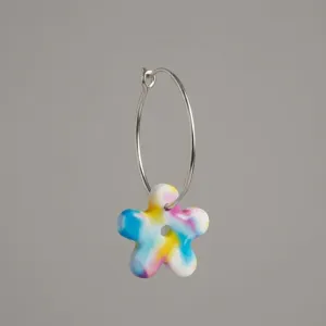 Handmade Buttercup polymer clay hoop flower earrings with stainless steel hoops.